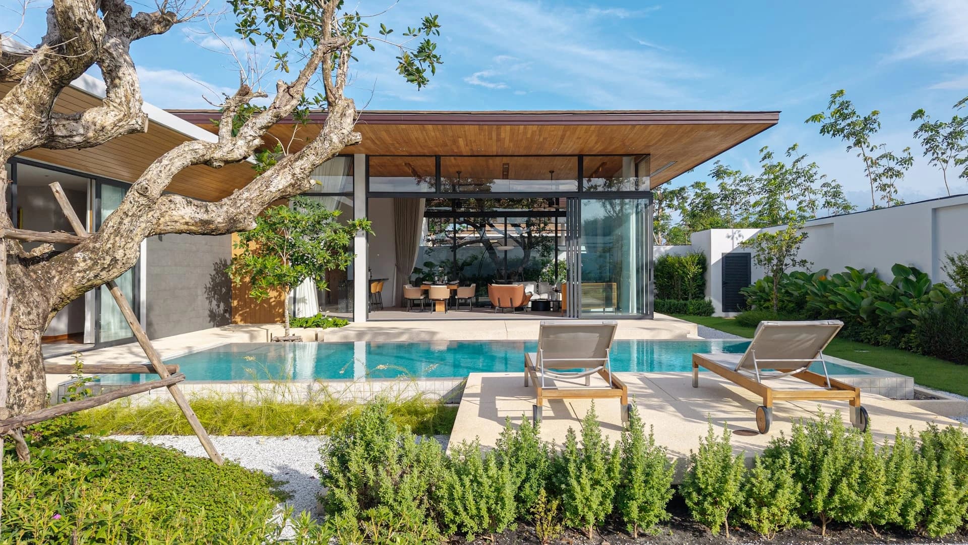 Spring villa pool terrace beneath a timber roof